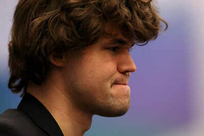 Magnus Carlsen deep in thought during a chess match.
